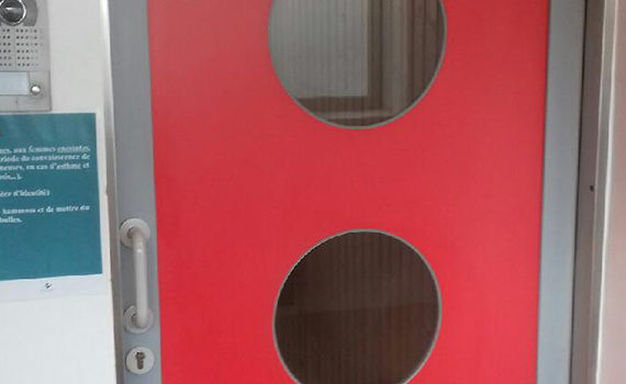 red polyethylene service door with portholes