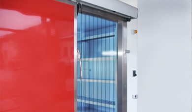 strip curtain and sliding insulated door in front of the cold room