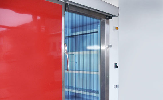 strip curtain and sliding insulated door in front of the cold room