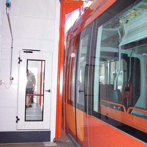 door with flexible leaves opening passage of tram rails